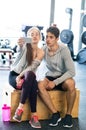 Fit couple in modern crossfit gym with smartphone. Royalty Free Stock Photo