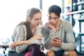 Fit couple in modern crossfit gym with smartphone. Royalty Free Stock Photo