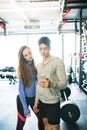 Fit couple in modern crossfit gym with smartphone. Royalty Free Stock Photo