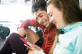 Fit couple in modern crossfit gym with smartphone. Royalty Free Stock Photo