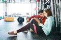 Fit couple in modern crossfit gym with smartphone. Royalty Free Stock Photo