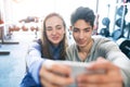 Fit couple in modern crossfit gym with smartphone. Royalty Free Stock Photo