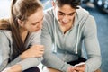 Fit couple in modern crossfit gym with smartphone. Royalty Free Stock Photo