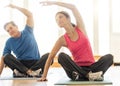 Fit Couple Practicing Yoga On Mat At Home