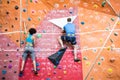 Fit couple rock climbing indoors