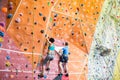 Fit couple rock climbing indoors