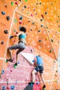 Fit couple rock climbing indoors