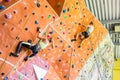 Fit couple rock climbing indoors Royalty Free Stock Photo