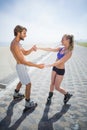 Fit couple rollerblading together on the promenade Royalty Free Stock Photo