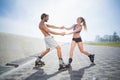 Fit couple rollerblading together on the promenade Royalty Free Stock Photo