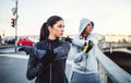 A fit couple runners doing stretching outdoors on the bridge in Prague city. Royalty Free Stock Photo