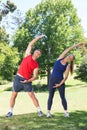 Fit couple stretching in the park Royalty Free Stock Photo