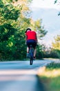 Fit cyclist rides his bicycle bike on an empty road in nature Royalty Free Stock Photo