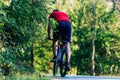 Fit cyclist rides his bicycle bike on an empty road in nature Royalty Free Stock Photo