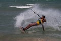 Fit dark-skinned male kite surfing on the water near Kudawa beach, Sri Lanka