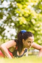 Fit determined brunette doing push ups