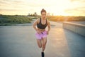 Fit determined young woman out jogging