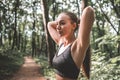 Pretty young woman preparing hair for her run in forest Royalty Free Stock Photo