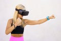 Sportswoman in VR headset boxing with hands