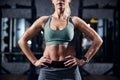 Determined athlete putting the hands on her belt