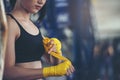 Fit Female strap on her wrist and exercise hard to strengthen muscle.Boxing Woman prepare to trianing session and kickboxing, Royalty Free Stock Photo