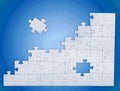 Fitting last puzzle piece on blue background