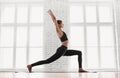 Fit girl doing exercises, practicing yoga in class. Young woman meditating at home. Training, harmony, balance, meditation concept Royalty Free Stock Photo