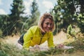 Fit girl doing plank exercise outdoor in park warm summer day, activity with stretch legs. Smile sportswoman  training isolaition Royalty Free Stock Photo