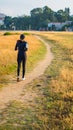 fit girl jogging on a beatiful road