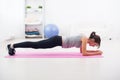 Fit girl in plank position on mat at home the Royalty Free Stock Photo