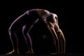 Fit girl practicing yoga in a studio. Half silhouette side lit fitness model