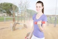 Fit girl sporty slim portrait with dumbbell in exercise outdoor Royalty Free Stock Photo