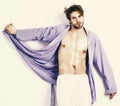 Fit guy with torso and six packs in blue bathrobe. Sportsman with body in home clothes. Morning concept. Royalty Free Stock Photo