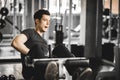 Fit handsome caucasian man sit up on machine in sportswear. Young man sit up exercise to strengthen Royalty Free Stock Photo