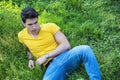 Fit handsome young man relaxing lying on lawn grass Royalty Free Stock Photo