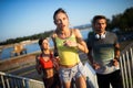 Fit happy friends jogging and running together outdoor in city Royalty Free Stock Photo