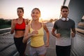 Fit happy friends jogging and running together outdoor in city Royalty Free Stock Photo