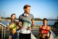 Fit happy friends jogging and running together outdoor in city Royalty Free Stock Photo