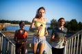 Fit happy friends jogging and running together outdoor in city Royalty Free Stock Photo