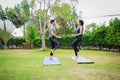 Fit happy people working out outdoor. Asian couple exercising together on a yoga mat at home garden. Family outdoors. exercise at Royalty Free Stock Photo