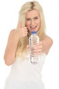 Fit Healthy Positive Happy Young Blonde Woman Holding a Bottle of Mineral Water Royalty Free Stock Photo