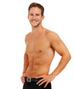 Fit and healthy. Studio portrait of a handsome young man posing shirtless against a white background. Royalty Free Stock Photo