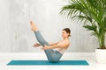 Fit healthy woman doing a Navasana Yoga Pose or Boat Pose Royalty Free Stock Photo