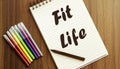 Fit Life. your future target searching, a marker, pen, three colored pencils and a notebook for writing