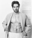 Fit macho in bathrobe with torso and six packs. Royalty Free Stock Photo