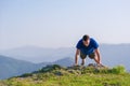 Fit male athlete doing pushups at the edge of a cliff while enjoying the amazing view Royalty Free Stock Photo