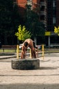 Crossfit woman exercising with big tire at urban place