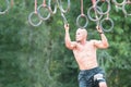 Fit Male Grasps Rings In Extreme Obstacle Course Race