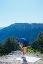 Fit male runner stretching his legs and getting ready for a long run  workout  early in the morning on a nice sunny day Royalty Free Stock Photo