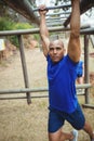 Fit man climbing monkey bars Royalty Free Stock Photo